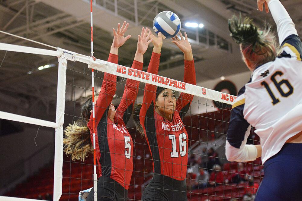 Junior setter Kristen McDaniel and freshman middle blocker Jada Allen block a spike from Notre Dame on Sunday, Nov. 7, 2021 in Reynolds Coliseum. The Wolfpack beat the Fighting Irish 3-2.