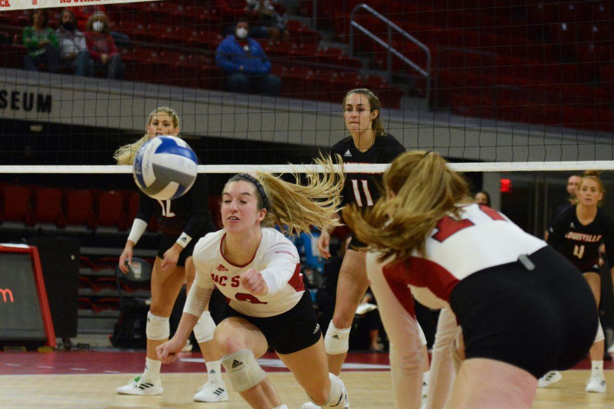 Freshman setter Maggie Jones dives for the ball on Friday, Nov. 5, 2021 in Reynolds Coliseum. Jones had three assists during the match. The Louisville Cardinals beat the NC State Wolfpack by 3-0.