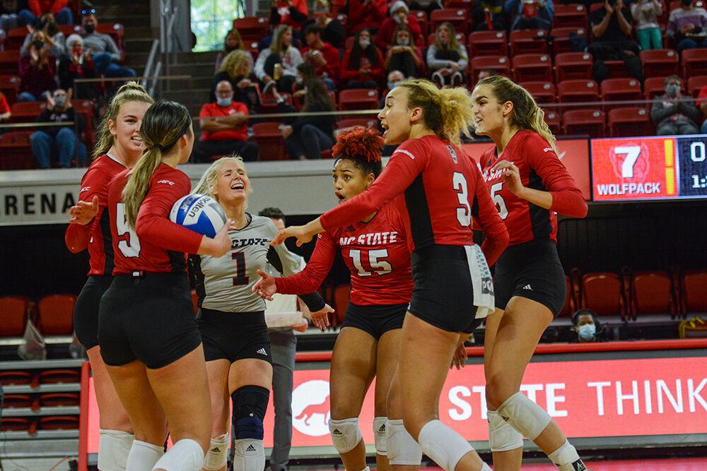 The team celebrates together during NC State's match against Notre Dame on Sunday, Nov. 7, 2021 in Reynolds Coliseum. The Wolfpack had 85 digs against the Irish during the 3-2 win.