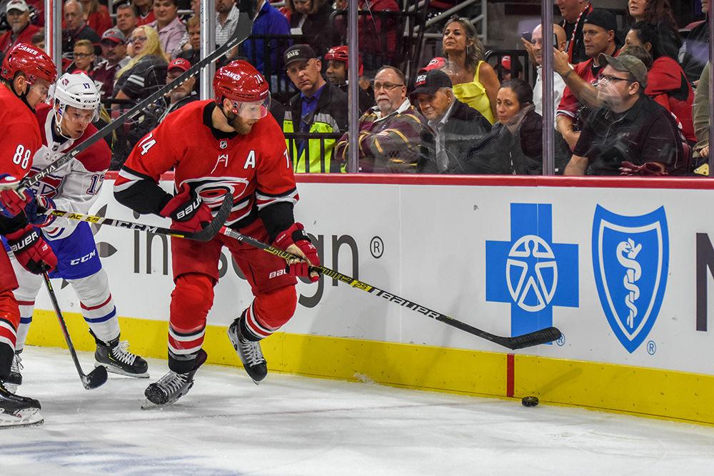 Carolina Hurricanes defenseman Jaccob Slavin maintains control of the puck during the first game of the NHL season on Thursday, Oct. 3, 2019 in PNC Arena. Slavin was announced to be an alternate captain alongside left wing Jordan Martinook during the 2019-2020 season. The Canes beat the Canadiens 4-3 after an overtime period and shootout.