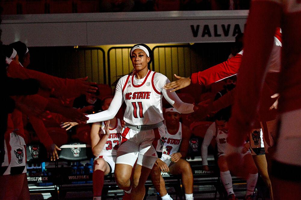 Junior wing Jakia Brown-Turner high fives her teammates before the game against UNC Pembroke on Wednesday, Nov. 3, 2021 at Reynolds Coliseum. Brown-Turner had nine rebounds and the Wolfpack beat the Braves 92-36 during the exhibition game.