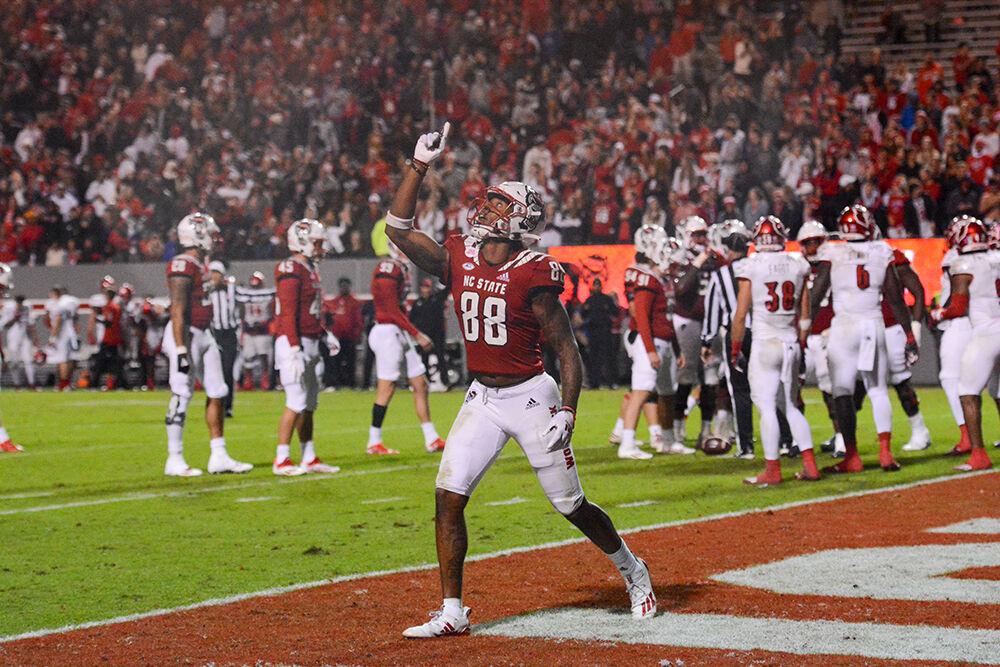 Redshirt sophomore wide receiver Devin Carter celebrates after NC State scores at the Homecoming game against Louisville at Carter-Finley Stadium on Saturday, Oct. 30, 2021. The Wolfpack won 28-13 against the Cardinals.