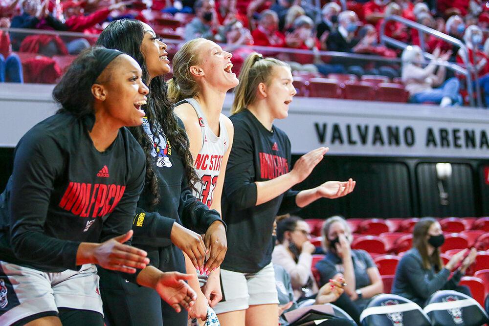 The bench celebrates a play during the game against Towson. NC State took down Towson 100-52 in Reynolds Coliseum on Monday, Nov. 15, 2021.