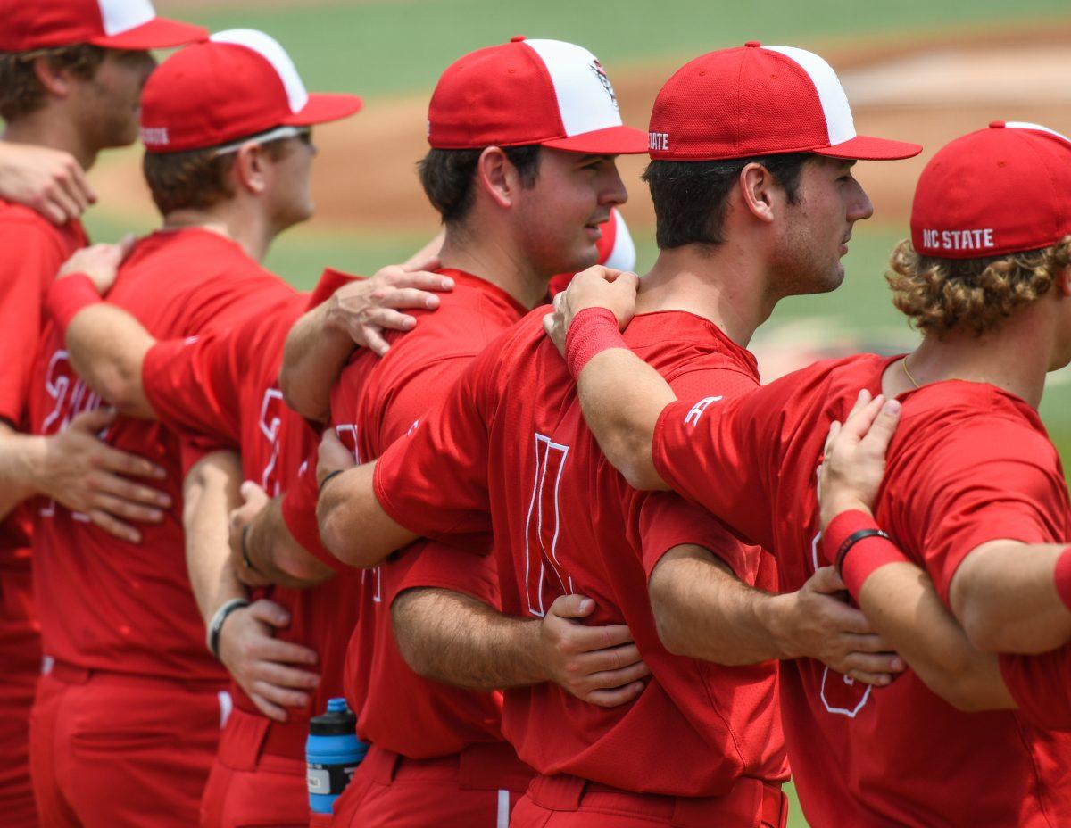The NC State Baseball team locks arms before the game versus the Florida State Seminoles on Saturday, May 22, 2021 in Doak Field at Dail Park. The Wolfpack lost to the Seminoles 15-11.