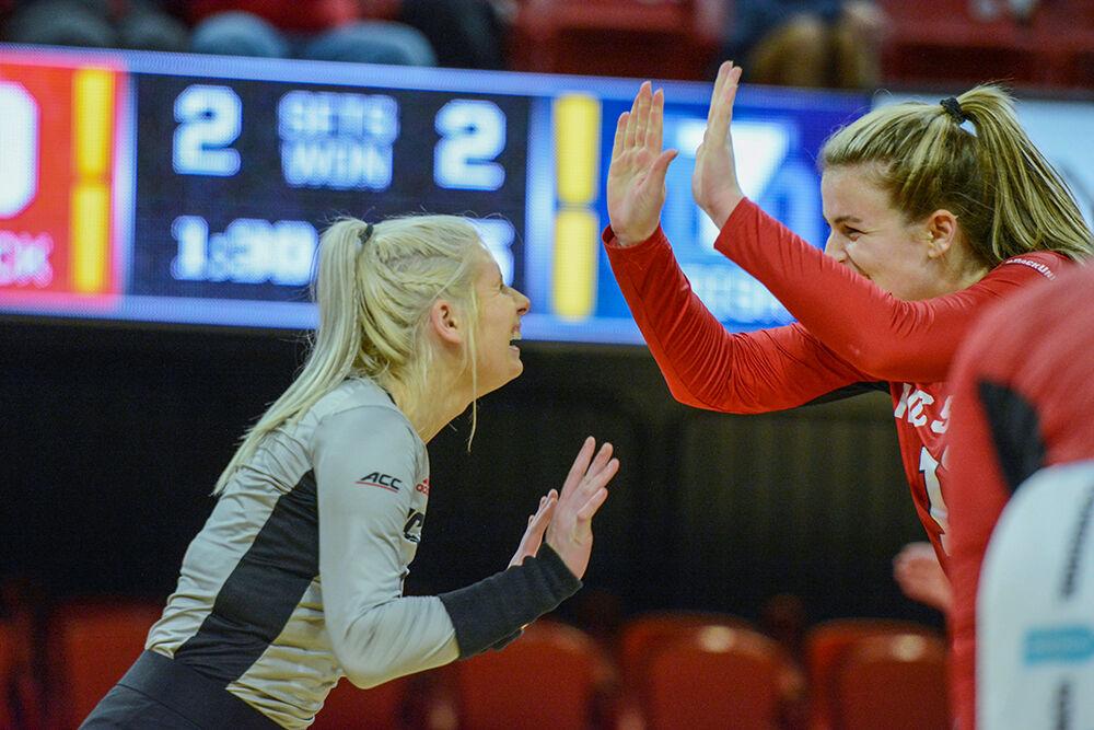 Graduate libero Kaylee Frazier and redshirt junior outside hitter Taylor Rowland celebrate a point with a high five during the game against Notre Dame on Sunday, Nov. 7, 2021 in Reynolds Coliseum. Rowland had 25 kills against Notre Dame. The Wolfpack beat the Fighting Irish 3-2.