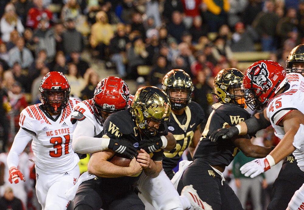 Graduate defensive lineman Daniel Joseph sacks Sam Hartman during NC State's game against Wake Forest on Saturday, Nov. 13, 2021 at Truist Field in Winston-Salem. The Wolfpack lost to the Demon Deacons 45-42.