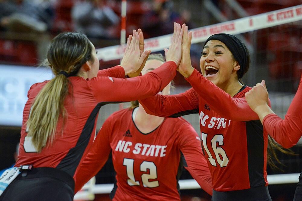 Freshman middle blocker Jada Allen high fives junior setter Kristen McDaniel after scoring a point against Notre Dame on Sunday, Nov. 7, 2021 in Reynolds Coliseum. The Wolfpack beat the Fighting Irish 3-2.
