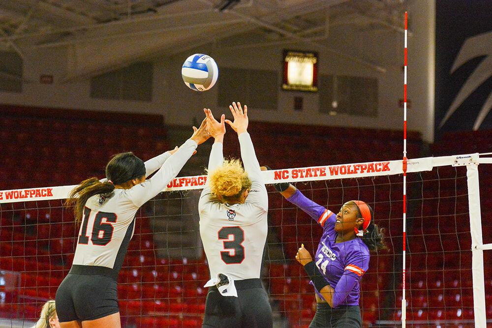 Graduate opposite hitter Melissa Evans and freshman middle blocker Jada Allen try to hit the ball back over in the match against Clemson on Saturday, Nov. 27, 2021 in Reynolds Coliseum. The Wolfpack beat the Tigers 3-1.