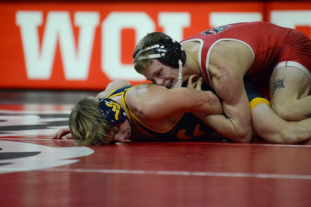 Redshirt freshman Kai Orie maintains control during the NC State match against West Virginia on Sunday, November 21, 2021 in Reynolds Coliseum. Orine won his individual match against the Mountaineers 4-1. The Pack beat the Mountaineers 34-6.