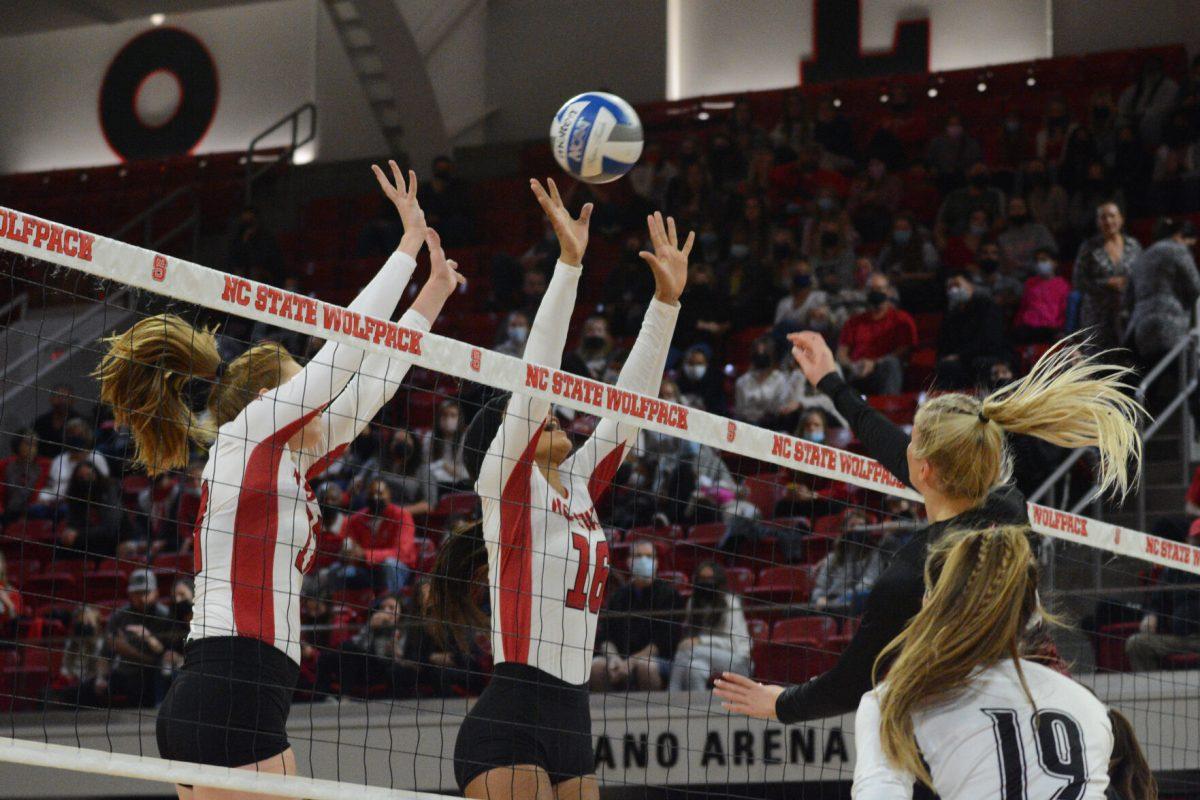 Junior setter Hannah Reid and Junior setter Kristen McDaniel look to block a Louisville spike Louisville spike on Friday, November 5, 2021 in Reynolds Coliseum. The Louisville Cardinals beat the Wolfpack 3-0.