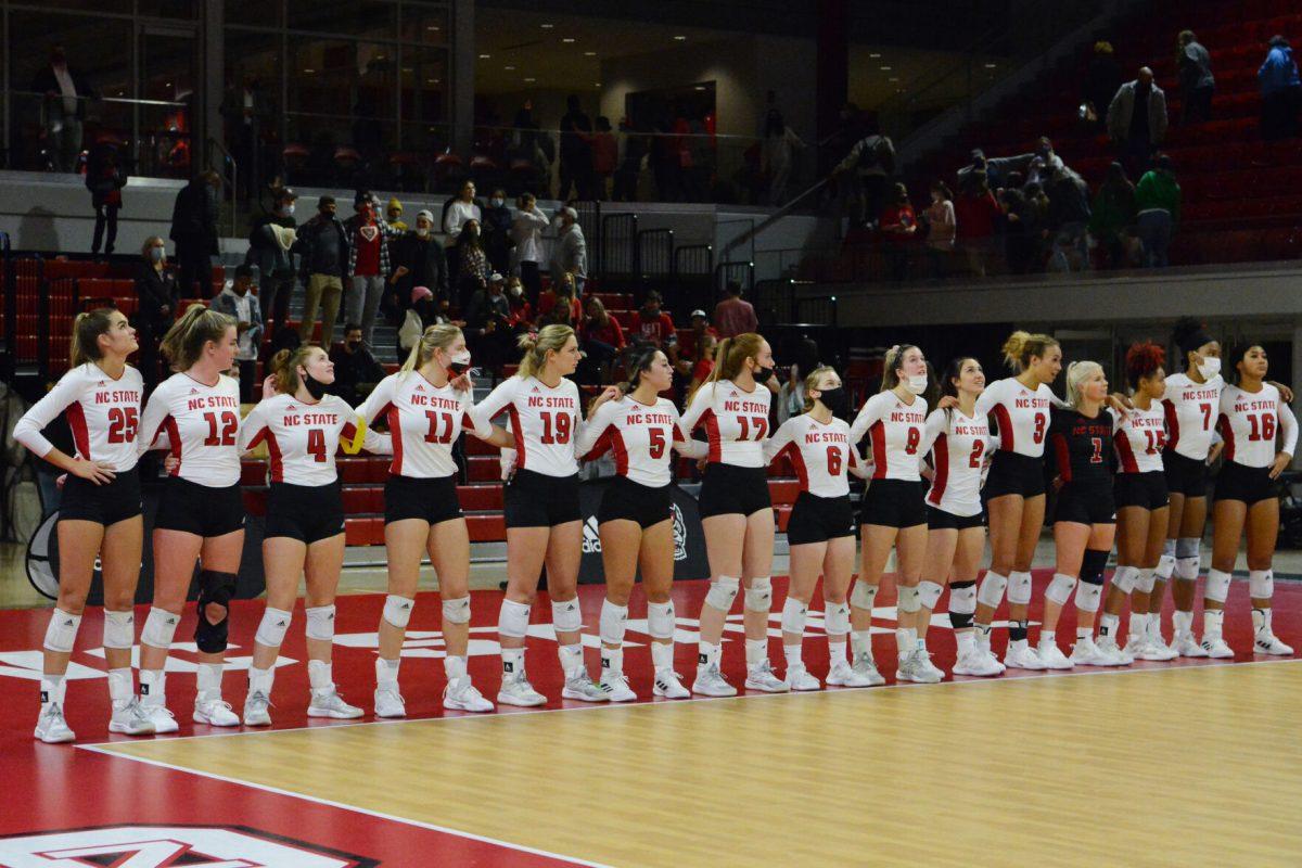 The NC State Volleyball team stands for the NC State Alma Mater on Friday, Nov. 5, 2021 in Reynolds Coliseum. NC State lost to Louisville 3-0.