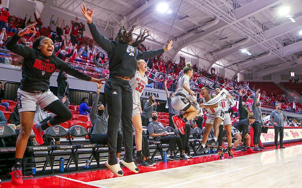 The bench celebrates a three that put the game at 100 points. NC State took down Towson 100-52 in Reynolds Coliseum on Monday, Nov. 15, 2021.