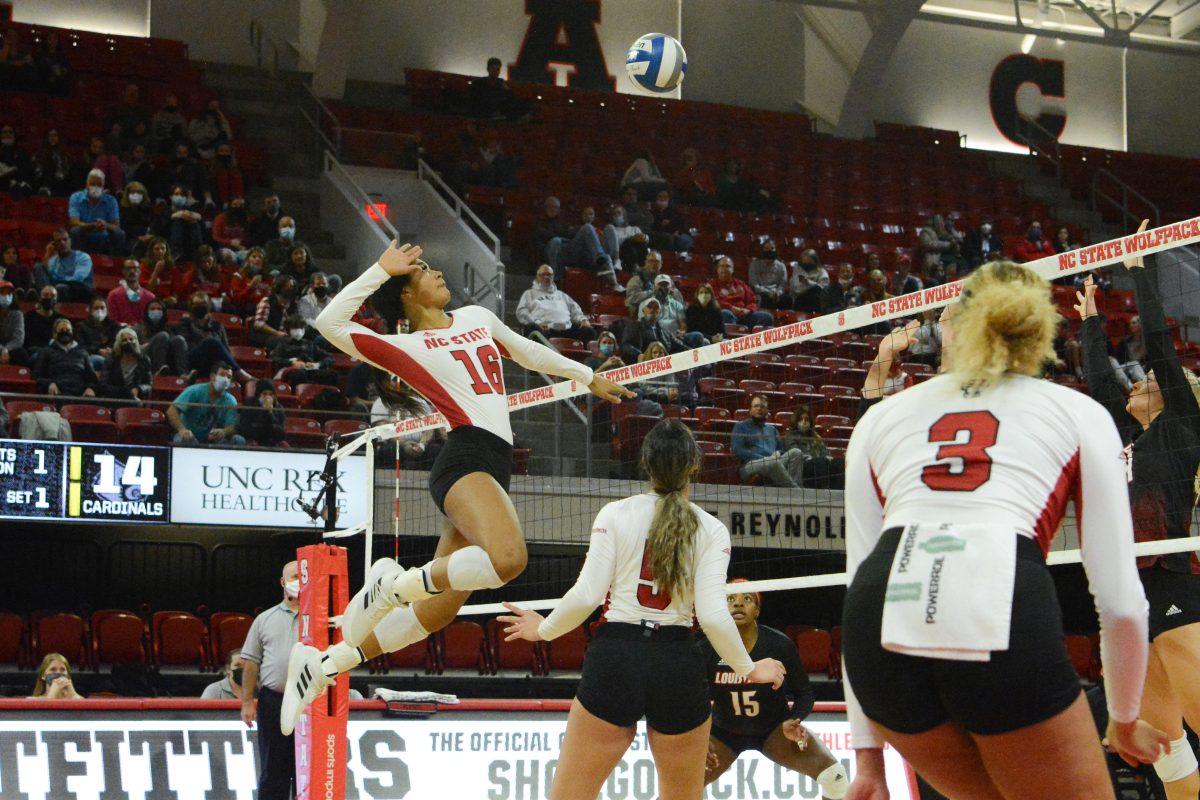 Freshman middle blocker Jada Allen spikes the ball over the net. Allen made three digs throughout the game. The Wolfpack lost to the Cardinals with a final score of 3-0.