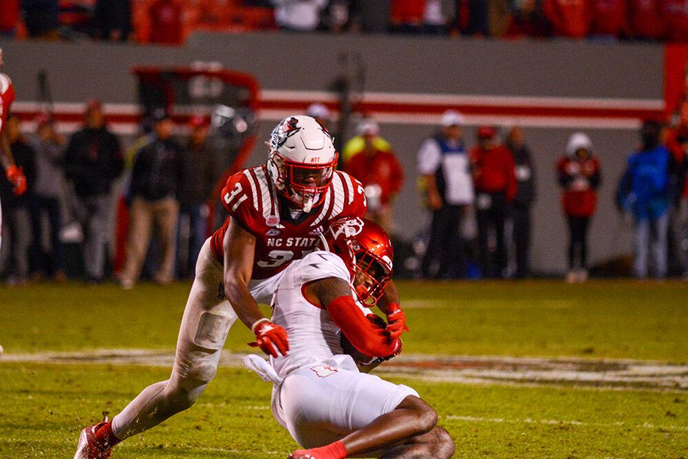 Redshirt junior LInebacker Vi Jones tackles a Louisville player on Oct. 30, 2021, at Carter-Finley Stadium. Jones contributed 7 tackles in the Wolfpack victory over the Cardinals, 28-13.