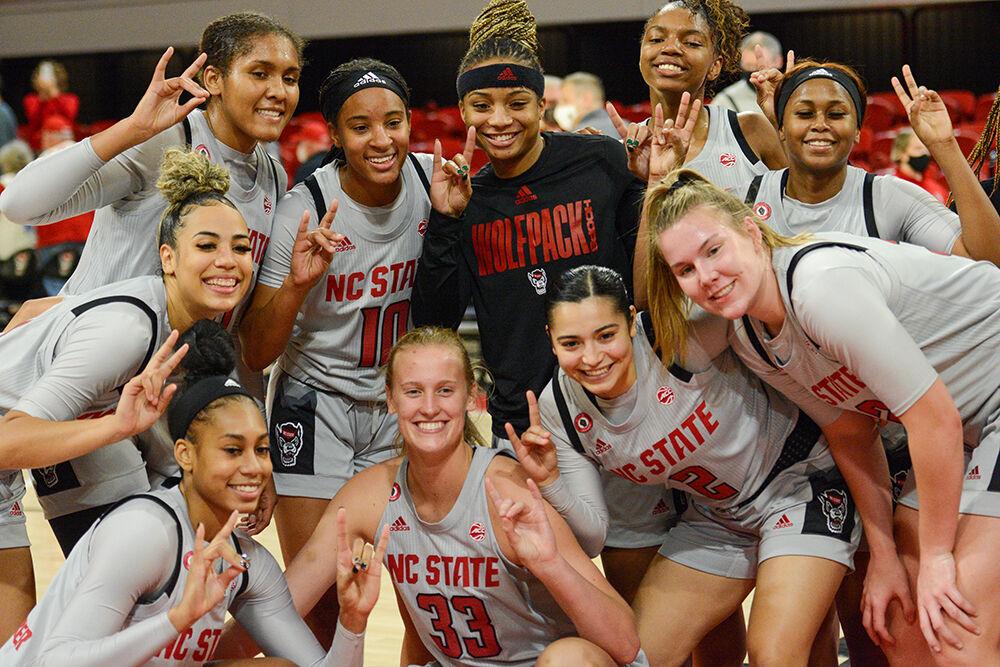The Woman's Basketball team celebrates their 100-52 victory over Towson at the William Reynolds coliseum on Monday, Nov. 15, 2021.