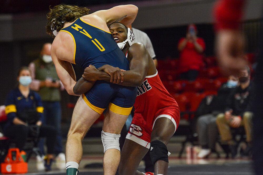 Graduate Tariq Wilson fights for a takedown during the NC State match against West Virginia on Sunday, November 21, 2021 in Reynolds Coliseum. Wilson won his individual match against the Mountaineers 13-4.&#160;The Pack beat the Mountaineers 34-6.