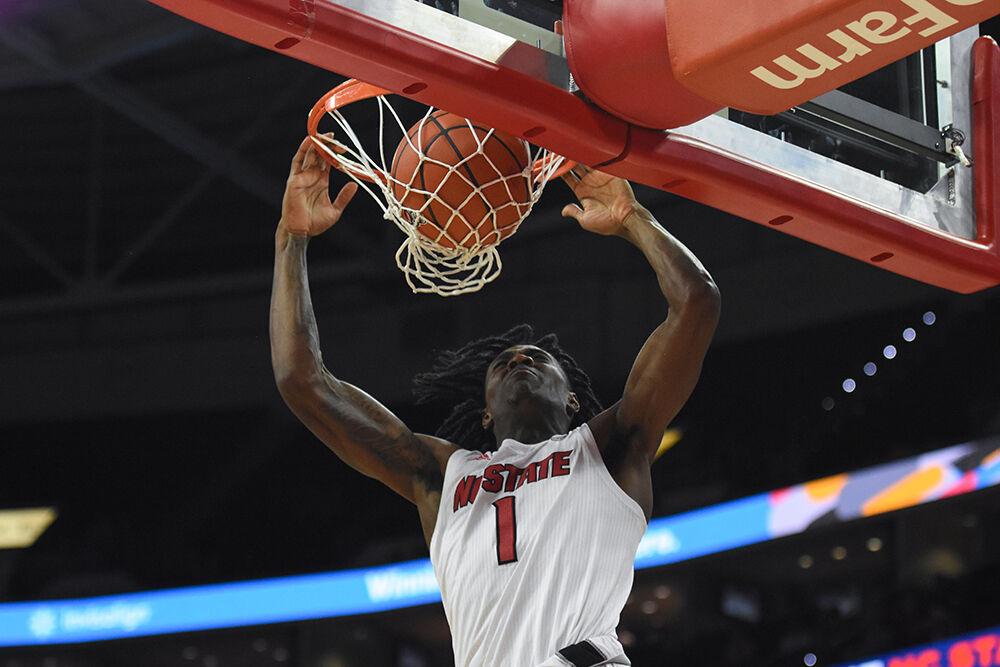 Redshirt sophomore guard Dereon Seabron dunks the ball in the game against Colgate on Saturday, Nov. 13, 2021 in PNC Arena. Seabron scored a total of 21 points helping lead to a Wolfpack win of 77-74.