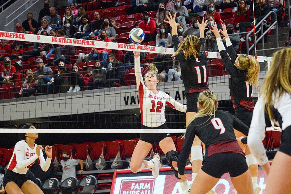 Junior opposite hitter Taylor Rowland blocks a Louisville spike on Friday, November 5, 2021 in Reynolds Coliseum. The Louisville Cardinals beat the Wolfpack 3-0.