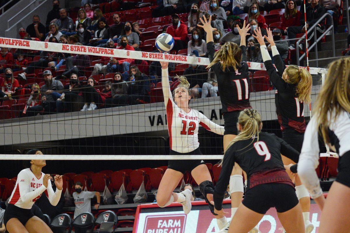 Junior opposite hitter Taylor Rowland blocks a Louisville spike on Friday, November 5, 2021 in Reynolds Coliseum. The Louisville Cardinals beat the Wolfpack 3-0.