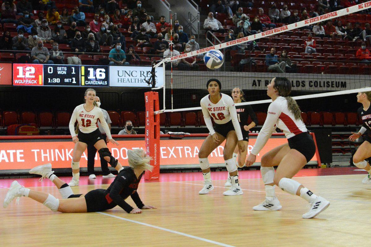 Graduate student defensive specialist and libero Kaylee Frazier dives for the ball while junior setter Kristen McDaniel hits. Frazier had four assists and McDaniel had 25 assists during this game. The Louisville Cardinals beat the NC State Wolfpack 3-0.