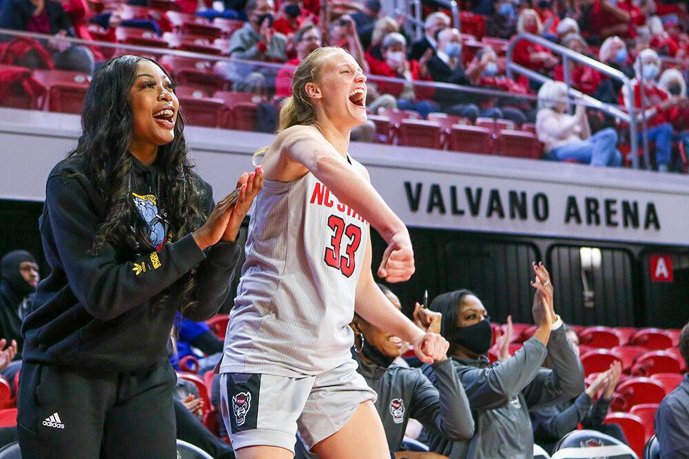 Junior forward Jada Boyd and Senior center Elissa Cunane celebrate a shot during the game against Towson. NC State took down Towson 100-52 in Reynolds Coliseum on Monday, Nov. 15, 2021.