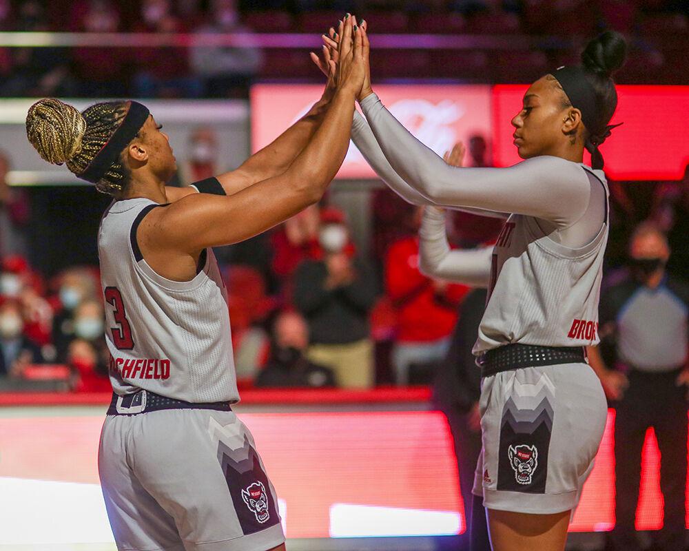 Graduate guard Kai Crutchfield fives Junior wing Jakia Brown-Tuner during her introduction. NC State took down Towson 100-52 in Reynolds Coliseum on Monday, Nov. 15, 2021.
