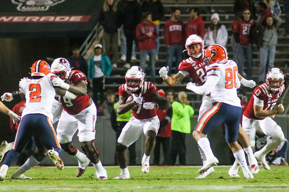 Sophomore running back Zonovan Knight carries the ball up the field at Carter-Finley on Saturday, Nov. 20, 2021. Knight had eight carries that totaled 37 yards throughout the game. The Wolfpack won 41-17 over the Orange.
