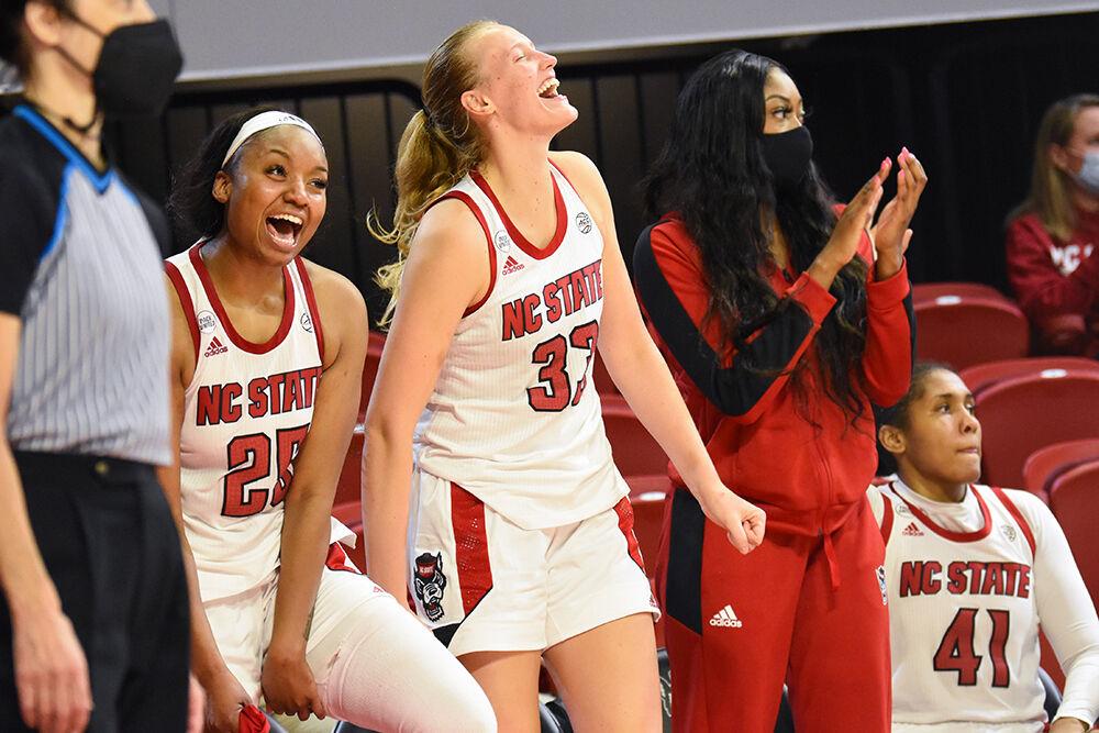 Graduate student forward Kayla Jones and senior center Elissa Cunane celebrate after their teammate makes a 3-point shot in the game against the Wofford Terriers on Friday, Nov. 12, 2021 in Reynolds Coliseum. The Wolfpack won 90-57.