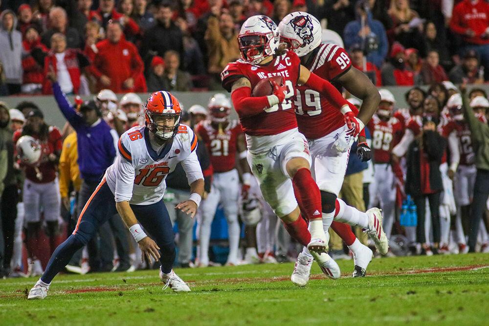 Sophomore linebacker Drake Thomas intercepts the ball and runs towards the end zone on Saturday, Nov. 20, 2021 at Carter-Finley Stadium. Thomas had four tackles and two sacks throughout the night. The Wolfpack won 41-17 against the Orange.