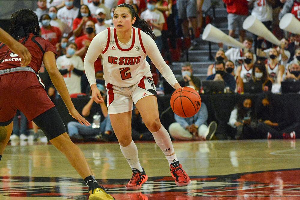 Graduate guard Raina Perez dribbles the ball up the court against Gamecock guard Destanni Henderson during the Wolfpack's home game against the top ranked South Carolina Gamecocks on Tuesday, Nov. 9, 2021 in Reynolds Coliseum. Perez tied with Brown-Turner to have the most points on the night for the Wolfpack with 18 points.&#160;The Wolfpack lost 66-57 against the Gamecocks.
