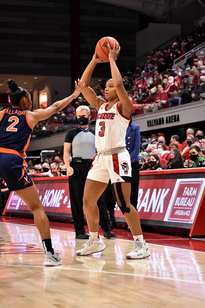Graduate guard Kai Crutchfield looks for an open teammate during the game against Virginia at Reynolds Coliseum on Sunday, Dec. 19, 2021. Crutchfield scored 19 points and the Wolfpack beat the Cavaliers 82-55.