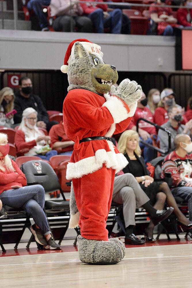 Mr. Wuf cheers on the crowd during the NC State women&#8217;s basketball game against Virginia on Sunday, Dec. 19, 2021 at Reynolds Coliseum. NC State beat Virginia 82-55.
