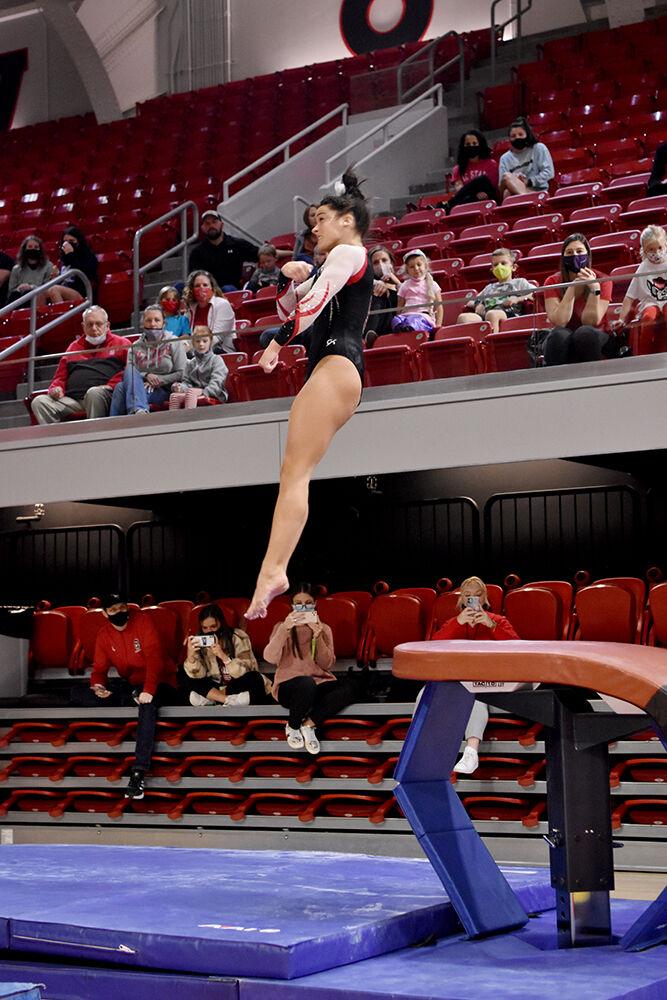 Freshman gymnast Hailey Merchant twists off the vaulting table at NC State&#8217;s Red and White Exhibition meet at Reynolds Coliseum on Friday, Dec. 17, 2021. Merchant was a part of the white team which beat the red team 10-7.
