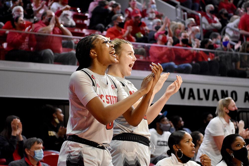 Junior forward Jada Boyd and freshman center Sophie Hart cheer after a teammate makes a shot against Georgia on Thursday, Dec. 16, 2021 at Reynolds Coliseum. The Wolfpack lost to the Bulldogs 82-80.