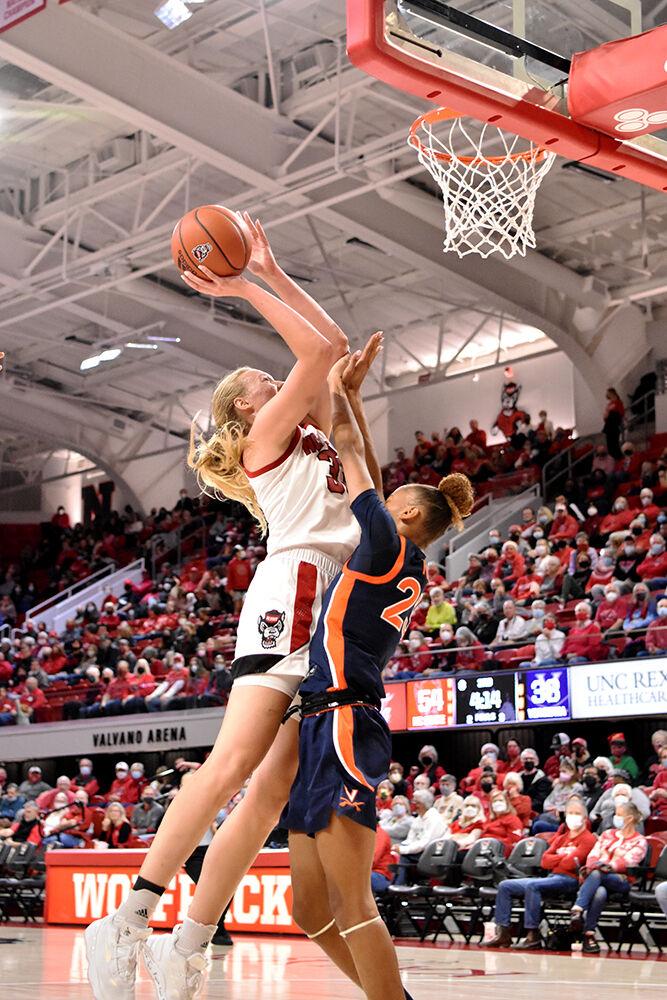 Senior center Elissa Cunane goes up for a shot against a Virginia defender at Reynolds Coliseum on Sunday, Dec. 19, 2021. Cunane had 14 points and 6 rebounds. NC State beat Virginia 82-55.
