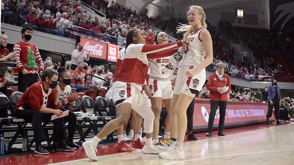 Graduate forward Kayla Jones and senior center Elissa Cunane celebrate after a shot against Virginia at Reynolds Coliseum on Sunday, Dec. 19, 2021. Cunane scored 14 points and had 6 rebounds during the game. NC State beat Virginia 82-55.