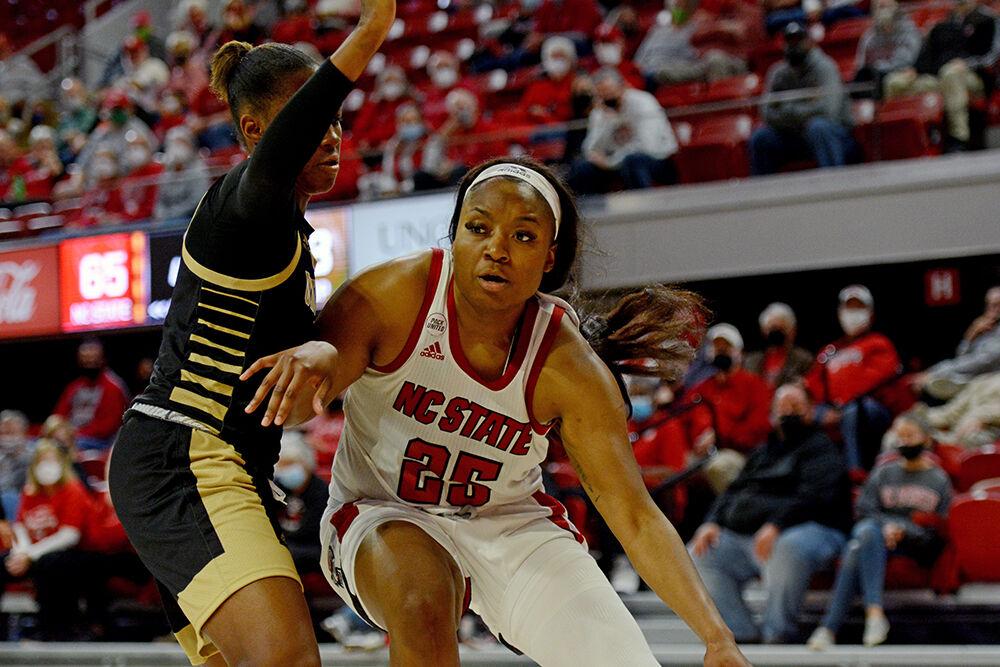 Graduate student forward Kayla Jones dribbles past a defender on Wednesday, Nov, 3, 2021 at Reynolds Coliseum. NC State played UNC Pembroke in an exhibition game and won 92-36.