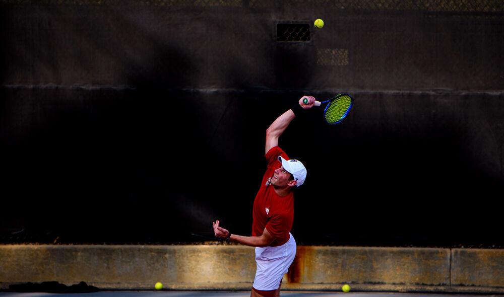 Sophomore Martins Rocens serves against Florida State on Friday, March 12, 2021 at J.W. Isenhour Tennis Center. The Wolfpack won 4-0.