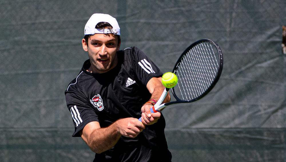 Sophomore Rafa Izquierdo Luque returns the ball against Texas on Sunday, March 1 at Cary Tennis Park. Izquierdo Luque and junior Collin Shick won their doubles match 6-4 and Izquierdo Luque lost his singles match 6-4, 6-0, but the Wolfpack ended up with a 4-3 team win.