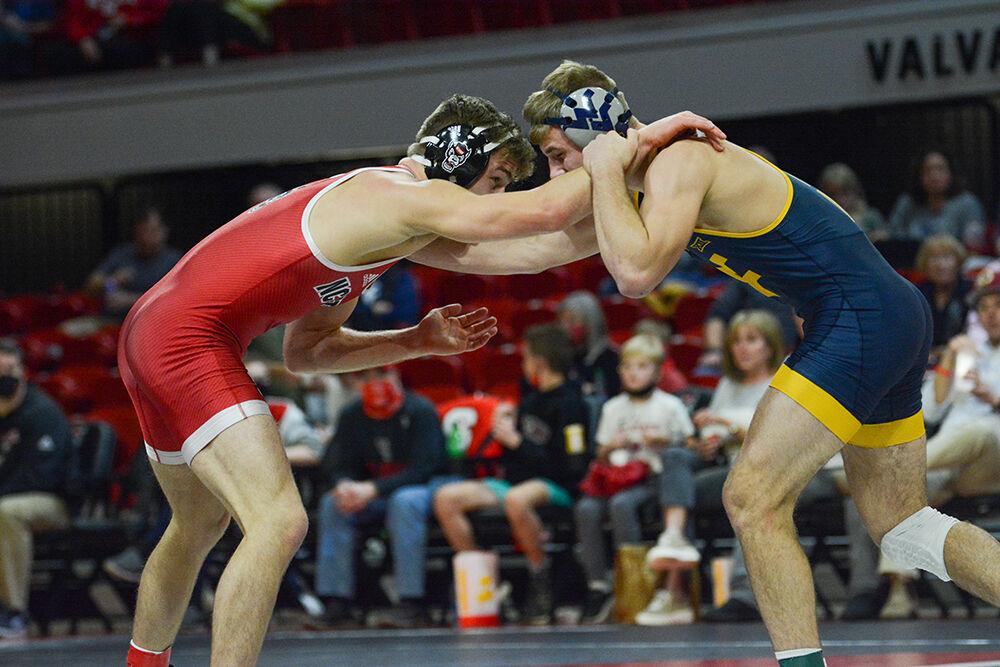 Graduate Thomas Bullard stares down his opponent during the NC State match against West Virginia on Sunday, November 21, 2021 in Reynolds Coliseum. Bullard won 6-3 in his individual match against the Mountaineers.&#160;The Pack beat the Mountaineers 34-6.