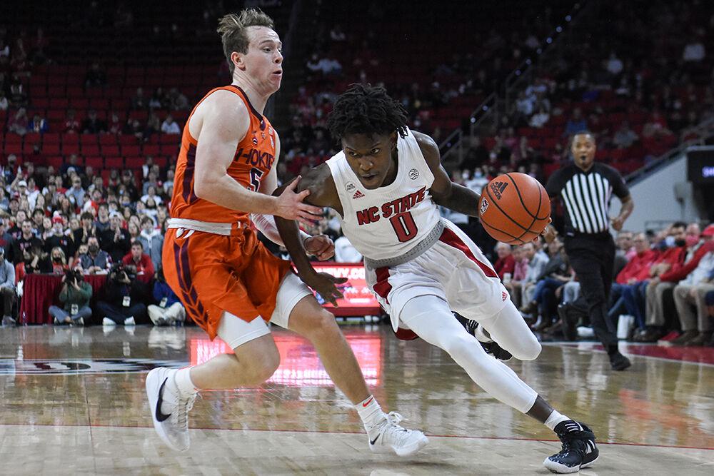 Freshman guard Terquavion Smith pushes past a Virginia Tech player to go to the basket during the game in PNC Arena on Wednesday, Jan. 19, 2022. Smith scored 14 points in the game. NC State lost 62-59.