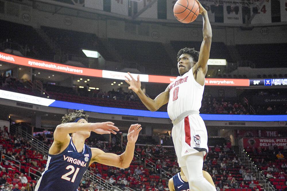Freshman guard Terquavion Smith dunks the ball against Virginia in the men's basketball home game against Virginia at PNC Arena on January 22, 2022. Smith contributed 20 points and three assists. NC State beat Virginia 77-63.&#160;