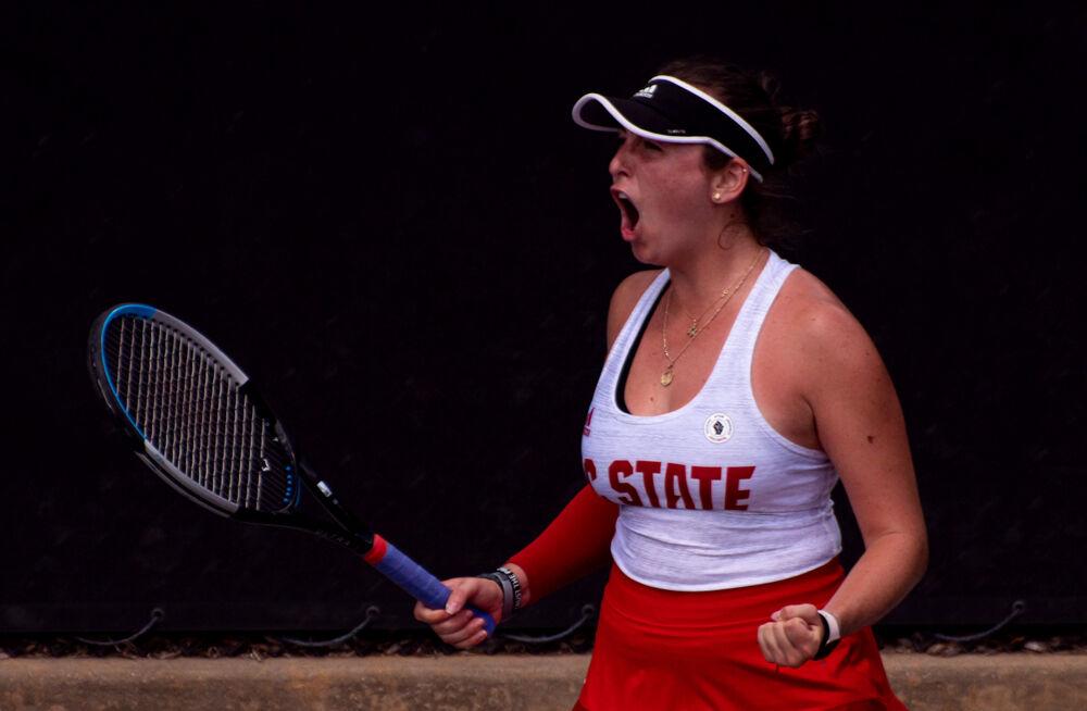 Freshman Abigail Rencheli celebrates winning a point against No. 12 Virginia on Sunday, April 11, 2021 at J.W. Isenhour Tennis Center. Rencheli won her doubles match with freshman Amelia Rajecki 6-1, as well as her singles match 6-1, 6-4. The Wolfpack won 4-3.