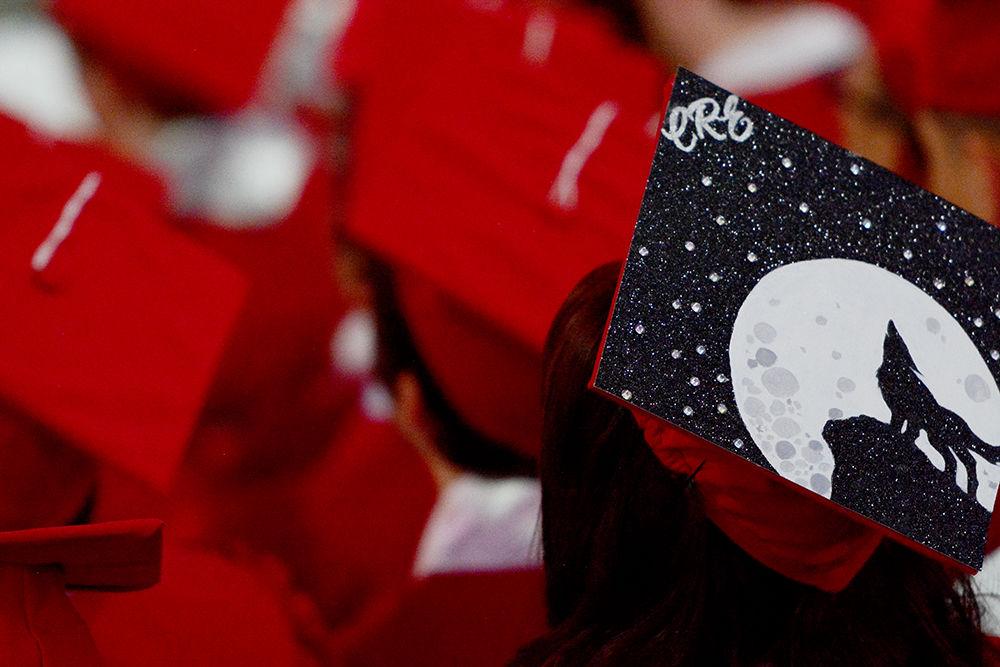 A graduate sits with her decorated cap on during the Commencement Ceremony on Saturday, May 11, 2019 in PNC Arena. It is a tradition to decorate your cap for graduation day.