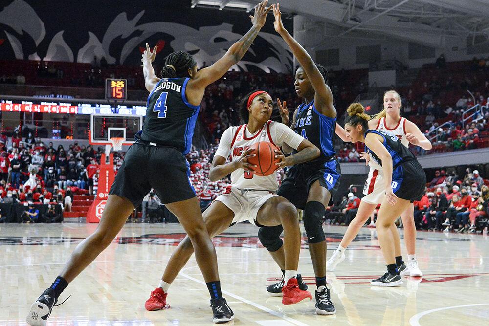 Junior forward Jada Boyd drives around defensive opponents in the game against Duke on Sunday, Jan. 16, 2022 in Reynolds Coliseum. Boyd scored ten points and contributed seven rebounds. NC State beat Duke 84-60.