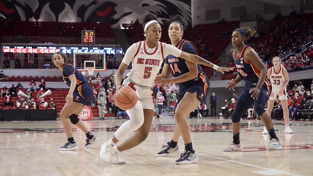 Junior forward Jada Boyd drives towards the paint against a Virginia defender at Reynolds Coliseum on Sunday, Dec. 19, 2021. Boyd scored 12 points and had 5 rebounds against Virginia. The Wolfpack beat the Cavaliers 82-55.