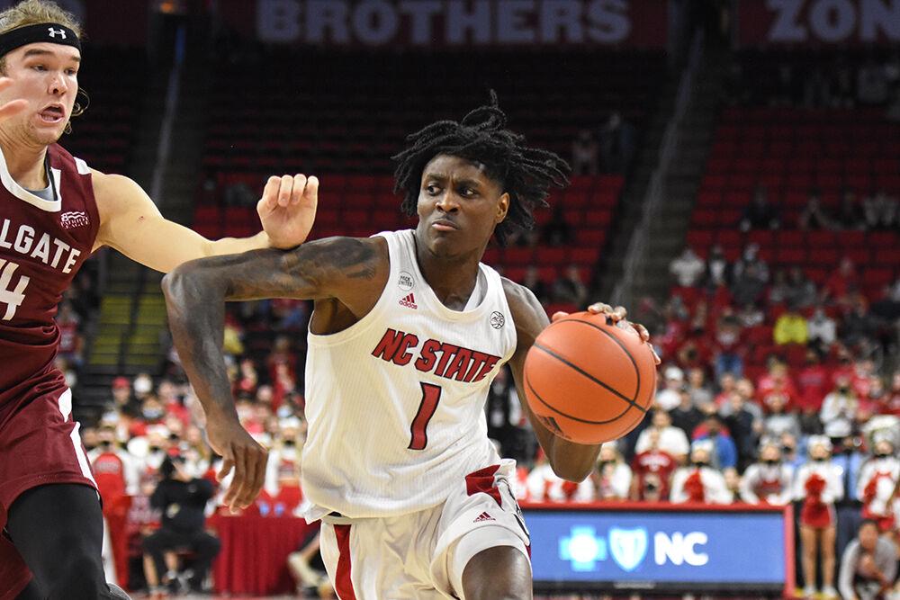 Redshirt sophomore guard Dereon Seabron pushes past a Colgate player on Saturday, Nov. 13, 2021 in PNC Arena. Seabron scored a total of 21 points helping lead to a Wolfpack win of 77-74.