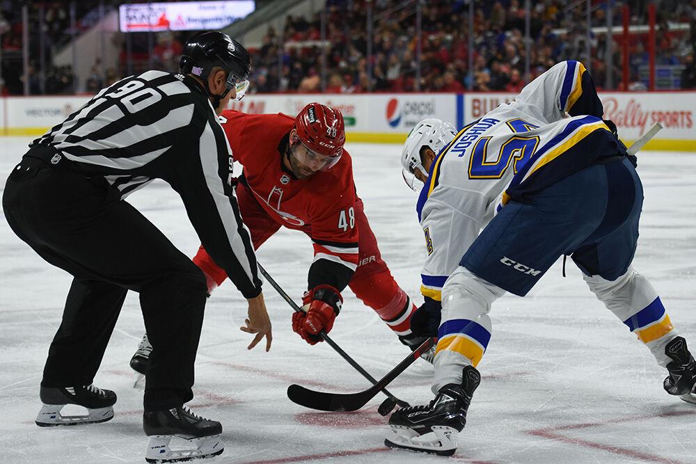 Left Wing Jordan Martinook goes against a St. Louis player in a faceoff during the game in PNC Arena on Saturday, Nov. 13, 2021. The Hurricanes beat the Blues 3-2.