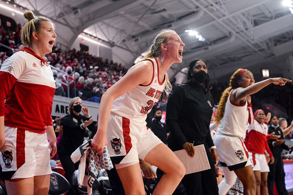 Senior center Elissa Cunane and the NC State bench cheer on their teammates in the game against Virginia Tech on Sunday, Jan. 23, 2022 in Reynolds Coliseum. Cunane scored seven points and contributed ten rebounds. NC State beat Virginia Tech 51-45.