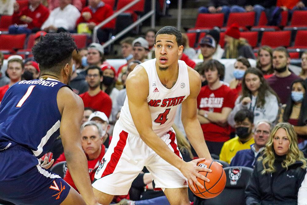Senior forward Jericole Hellems scans the court in the men's basketball home game against Virginia at PNC Arena on January 22, 2022. Hellems contributed 21 points and two assists. NC State beat Virginia 77-63.&#160;